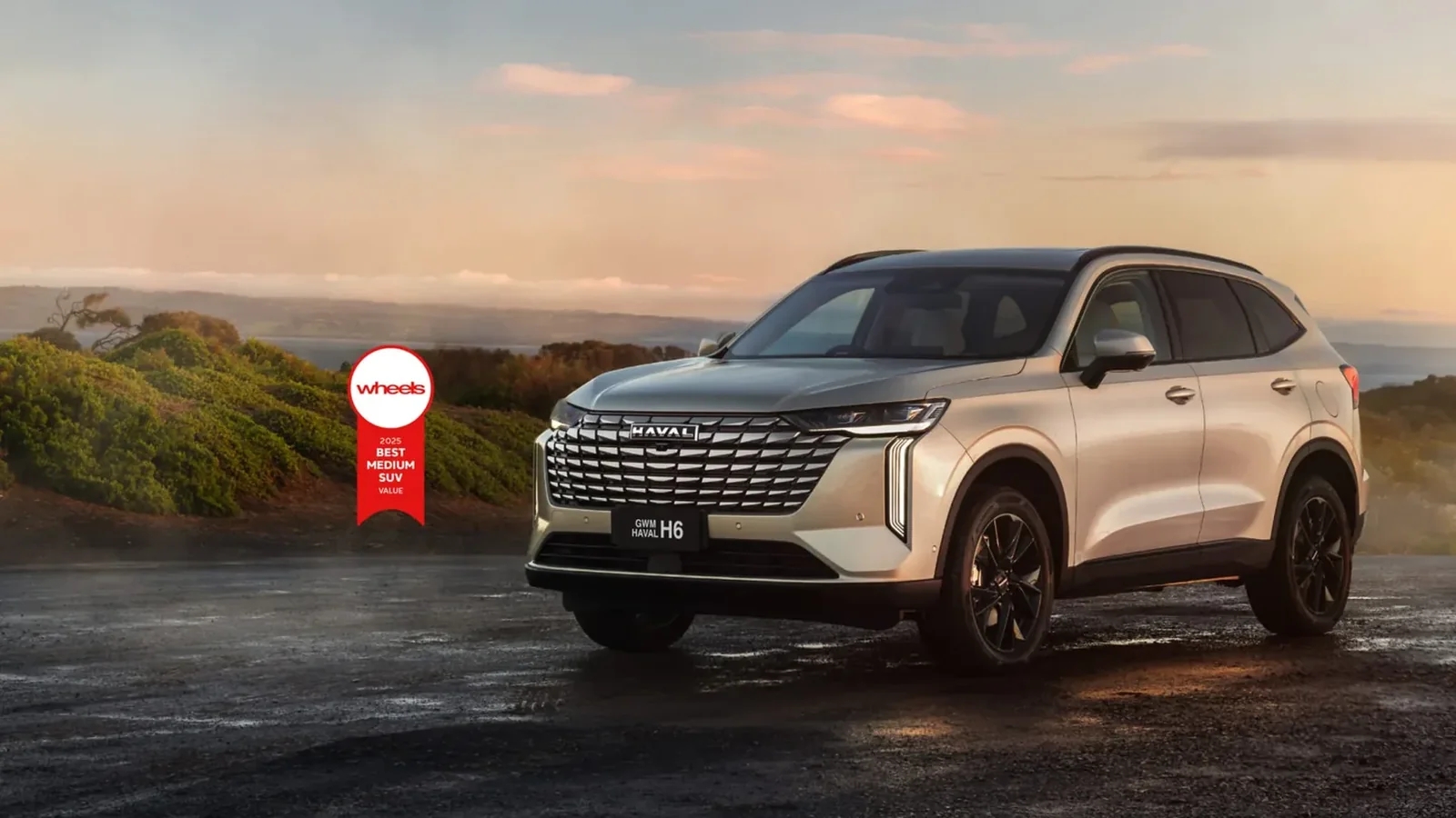 HAVAL H6 HEV hybrid car on the road at sunset